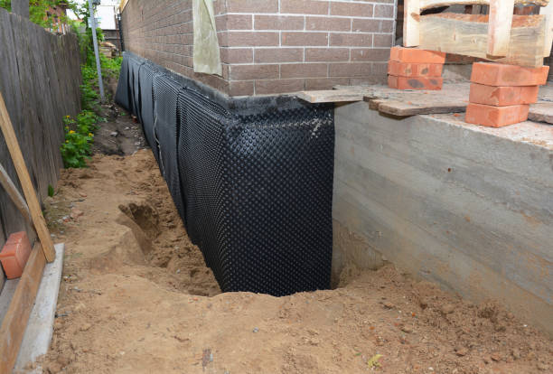 Happy homeowners after waterproofing job in Greensboro